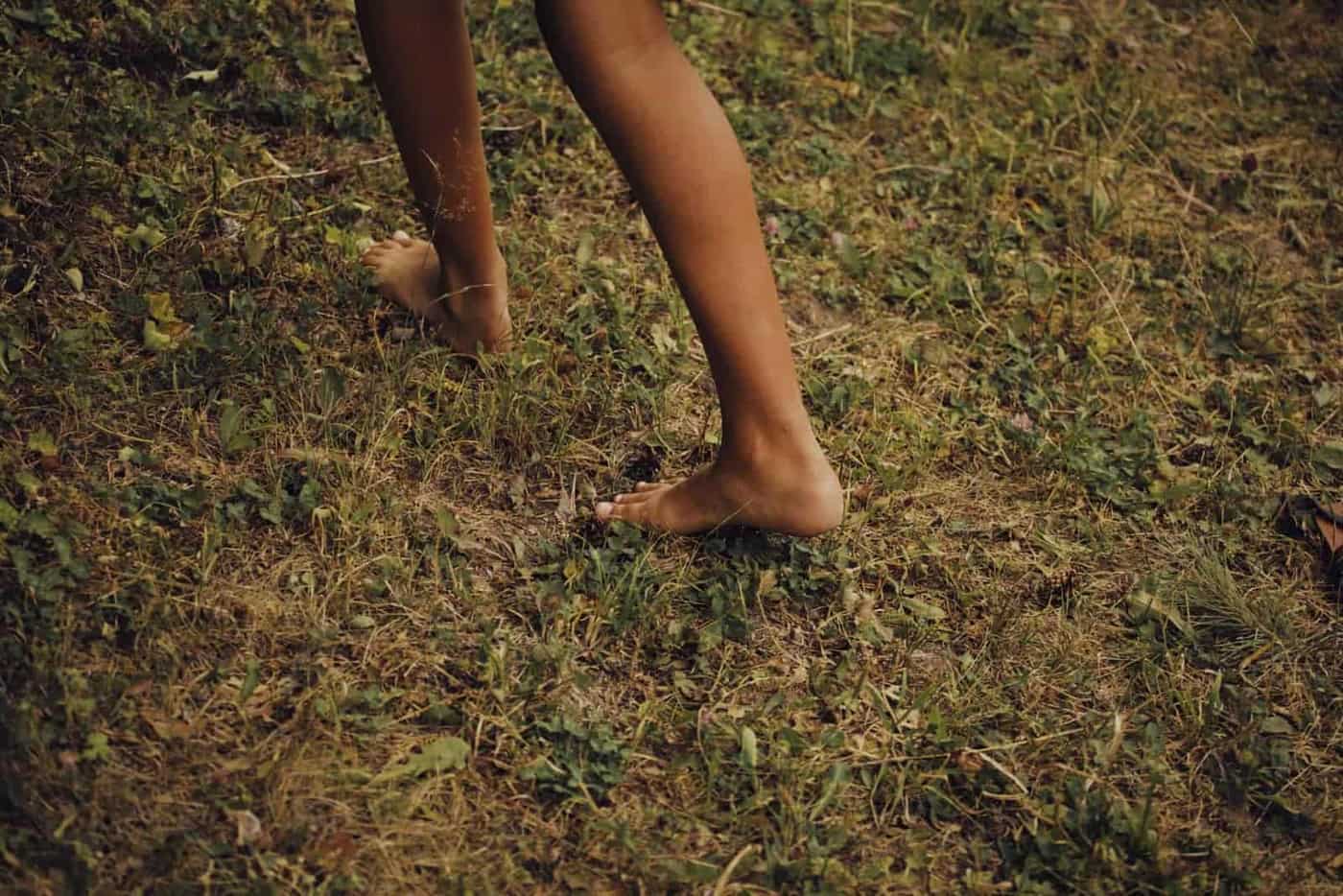 Bare feet walking on grass