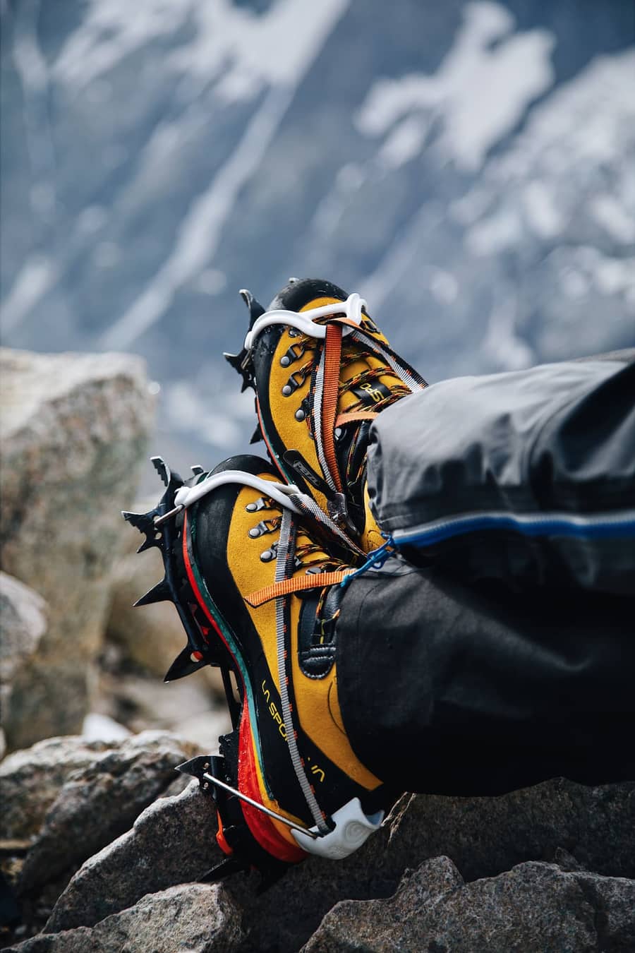 Mountaineering boots fitted with crampons on rocky ground