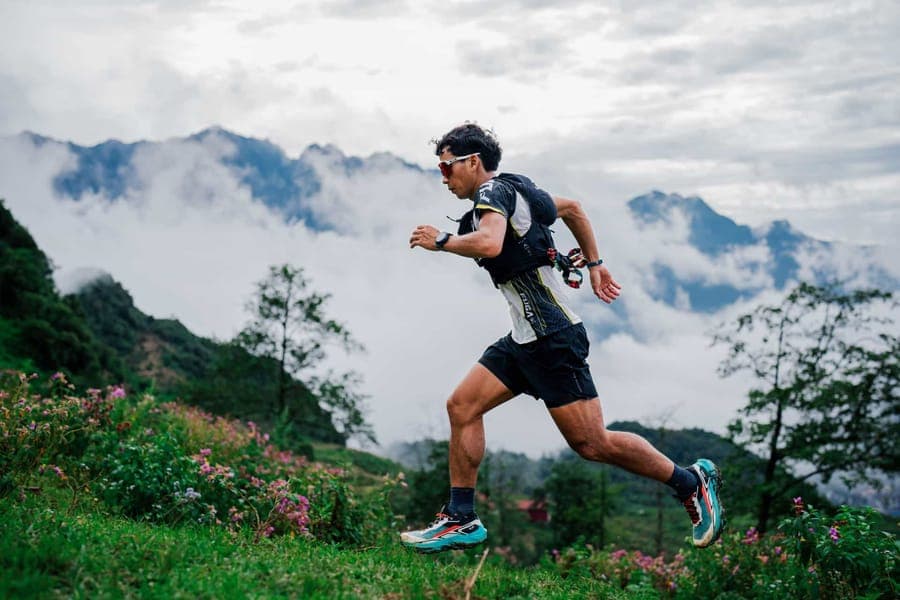 A trail runner on a misty mountain path